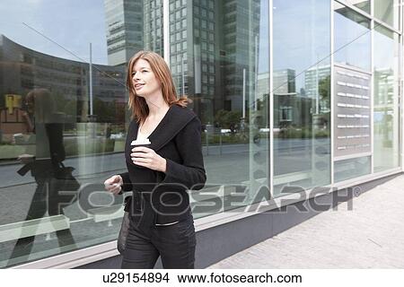 The Netherlands, Amsterdam, Businesswoman walking with coffee View Large Photo Image Picture - The Netherlands, Amsterdam, Businesswoman walking with coffee. Fotosearch
