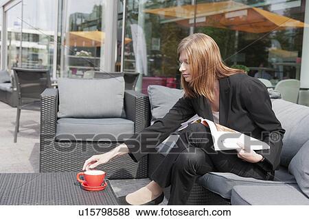 The Netherlands, Amsterdam, Businesswoman drinking coffee in sidewalk cafe View Large Photo Image Stock Photo - The Netherlands, Amsterdam, Businesswoman drinking coffee in sidewalk cafe. Fotosearch