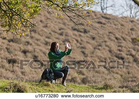 The Netherlands, Veluwezoom, Posbank, Hiker using camera in countryside View Large Photo Image Stock Image - The Netherlands, Veluwezoom, Posbank, Hiker using camera in countryside. Fotosearch