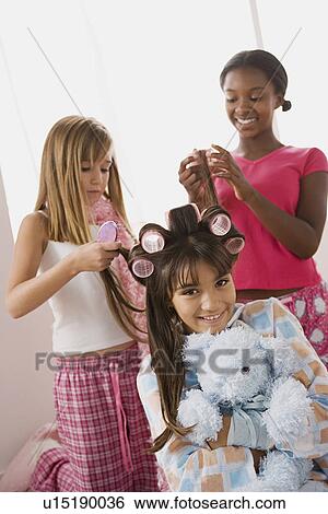Three girls (10-11) doing hair at slumber party View Large Photo Image Stock Photograph - Three girls (10-11) doing hair at slumber party. Fotosearch