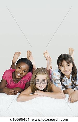 Three girls (10-11) having fun at slumber party View Large Photo Image Stock Image - Three girls (10-11) having fun at slumber party. Fotosearch