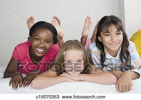 Three girls (10-11) having fun at slumber party View Large Photo Image Stock Image - Three girls (10-11) having fun at slumber party. Fotosearch