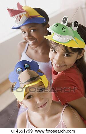 Stock Photo - Three girls (10-11) having fun at slumber party. Fotosearch