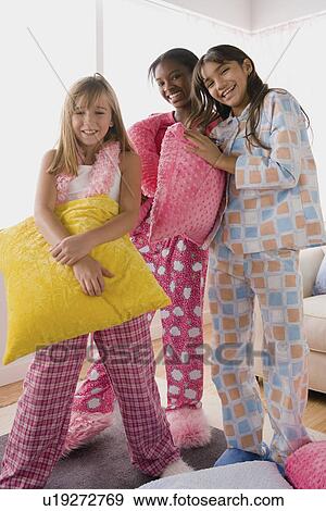 Three girls (10-11) having fun at slumber party View Large Photo Image Stock Photo - Three girls (10-11) having fun at slumber party. Fotosearch