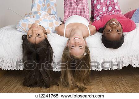 Three girls (10-11) having fun at slumber party View Large Photo Image Stock Photography - Three girls (10-11) having fun at slumber party. Fotosearch