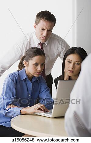Three people working in office View Large Photo Image Stock Photo - Three people working in office. Fotosearch