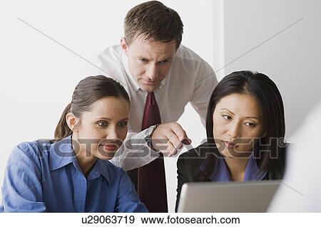 Three people working in office View Large Photo Image Stock Photo - Three people working in office. Fotosearch
