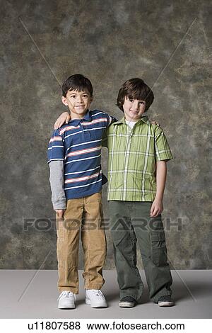Two boys (6-7, 8-9) standing together, studio shot View Large Photo Image Stock Photo - Two boys (6-7, 8-9) standing together, studio shot. Fotosearch