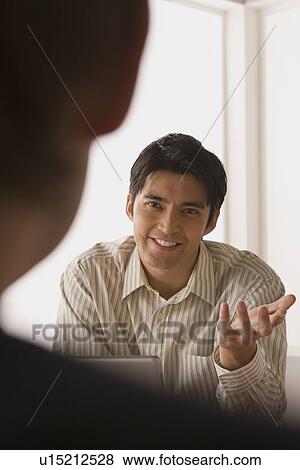 Stock Photo - Two businessmen in meeting. Fotosearch