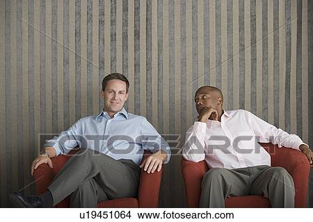 Two businessmen sitting on armchairs View Large Photo Image Picture - Two businessmen sitting on armchairs. Fotosearch