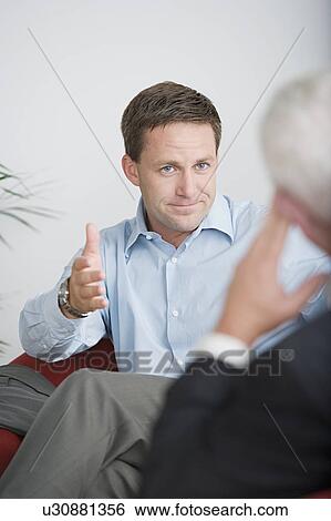 Stock Photograph - Two businessmen talking. Fotosearch