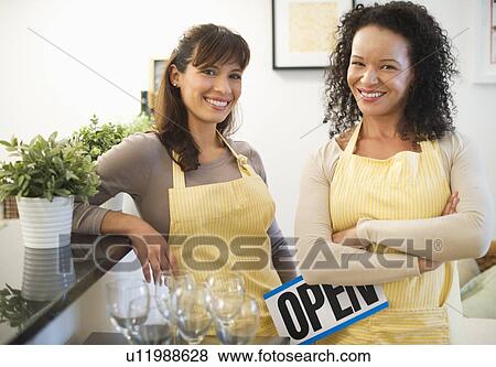 Stock Photo - Two female business owners in restaurant. Fotosearch