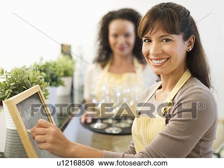 Stock Photo - Two female business owners in restaurant. Fotosearch