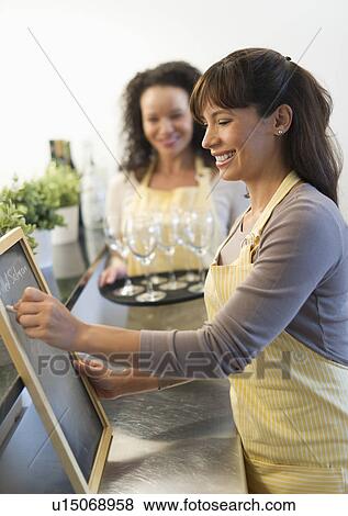 Stock Photo - Two female business owners in restaurant. Fotosearch
