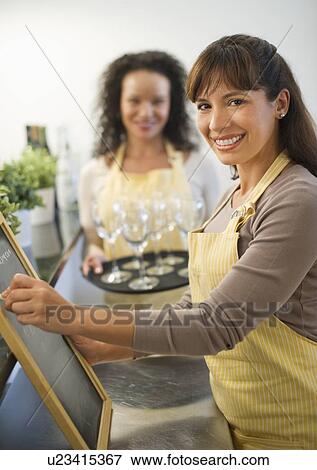 Stock Photo - Two female business owners in restaurant. Fotosearch