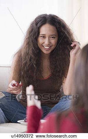 Two friends talking at home View Large Photo Image Stock Image - Two friends talking at home. Fotosearch