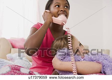 Stock Photo - Two girls (10-11) having fun at slumber party. Fotosearch