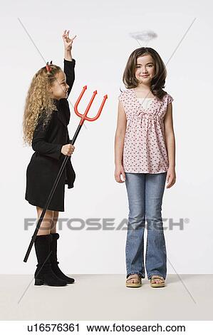 Two girls (8-9) dressed as angel and devil, studio shot View Large Photo Image Stock Image - Two girls (8-9) dressed as angel and devil, studio shot. Fotosearch