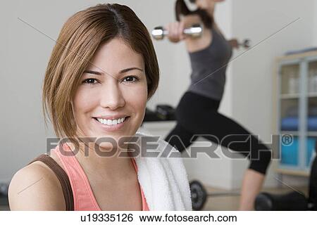 Two women exercising in gym View Large Photo Image Stock Photograph - Two women exercising in gym. Fotosearch