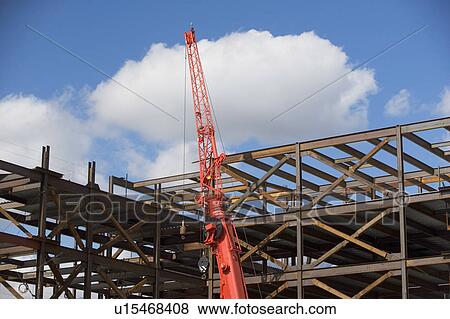 Stock Photo - Unfinished structure and crane at construction site. Fotosearch