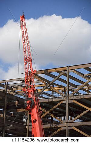 Stock Photograph - Unfinished structure and crane at construction site. Fotosearch