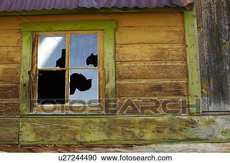 Stock Image - USA, Colorado, Abandoned log cabin with broken window. Fotosearch