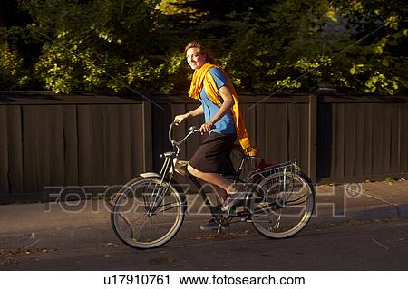 Stock Image - USA, Colorado, Woman riding bike. Fotosearch