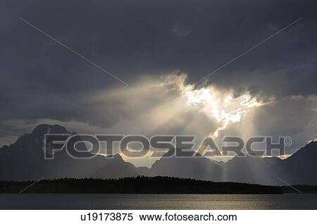 USA, Grand Teton National Park, Sunrays breaking through storm clouds View Large Photo Image Stock Photography - USA, Grand Teton National Park, Sunrays breaking through storm clouds. Fotosearch