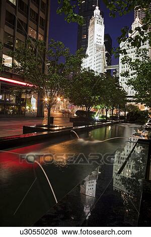 USA, Illinois, Chicago, Fountain and Wrigley Building illuminated at night View Large Photo Image Stock Photo - USA, Illinois, Chicago, Fountain and Wrigley Building illuminated at night. Fotosearch