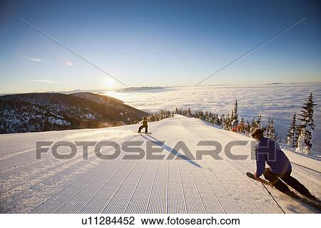 Stock Image - USA, Montana, Whitefish, Tourists on ski slope. Fotosearch