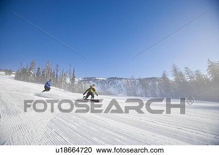 Stock Image - USA, Montana, Whitefish, Tourists on ski slope. Fotosearch