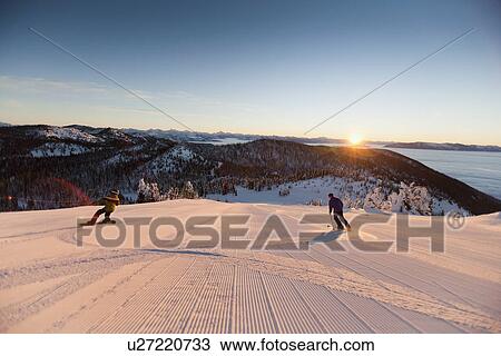 Stock Image - USA, Montana, Whitefish, Tourists on ski slope. Fotosearch
