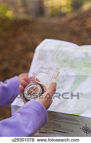 USA, New Jersey, Close-up of woman's hands holding compass and map View Large Photo Image Stock Photo - USA, New Jersey, Close-up of woman's hands holding compass and map. Fotosearch