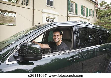 Stock Photo - USA, New Jersey, Portrait of man driving car. Fotosearch