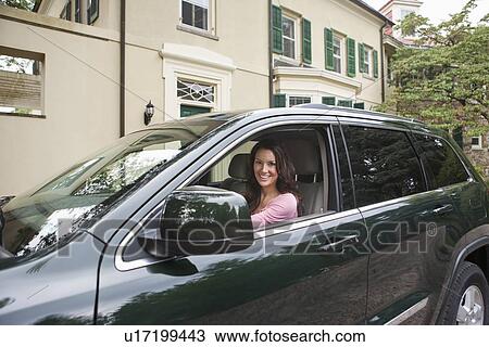 Stock Image - USA, New Jersey, Portrait of woman driving car. Fotosearch