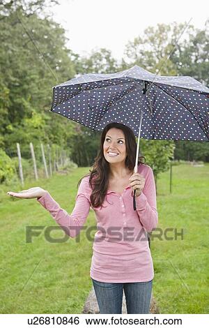 USA, New Jersey, Portrait of woman holding umbrella View Large Photo Image Stock Photograph - USA, New Jersey, Portrait of woman holding umbrella. Fotosearch