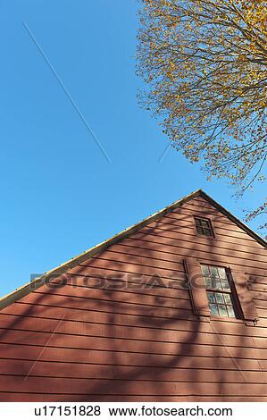 Stock Photo - USA, New Jersey, Top of cottage house against blue sky. Fotosearch