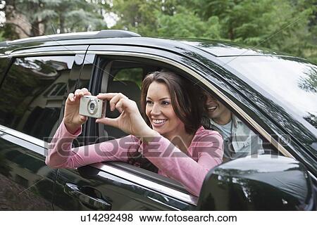 USA, New Jersey, Woman taking pictures from car View Large Photo Image Stock Photo - USA, New Jersey, Woman taking pictures from car. Fotosearch