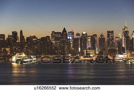 Stock Image - USA, New York City, Manhattan skyline at dusk. Fotosearch