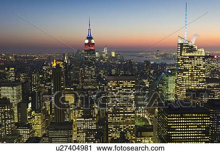 Stock Image - USA, New York City, Manhattan skyline at dusk. Fotosearch