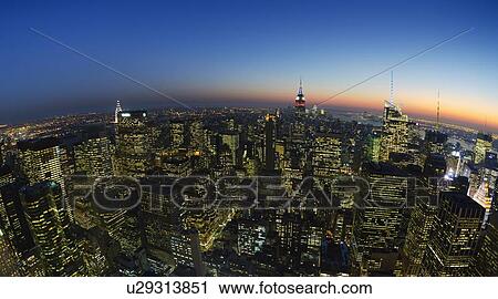 Stock Image - USA, New York City, Manhattan skyline at dusk. Fotosearch