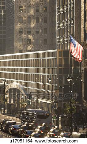 USA, New York City, Street scene with american flag flying outside office building View Large Photo Image Picture - USA, New York City, Street scene with american flag flying outside office building. Fotosearch