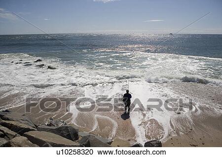 USA, New York, Long Island, Montaurk, Man fishing in sea View Large Photo Image Stock Image - USA, New York, Long Island, Montaurk, Man fishing in sea. Fotosearch