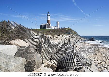Stock Image - USA, New York, Long Island, Montaurk, Coastline with lighthouse. Fotosearch