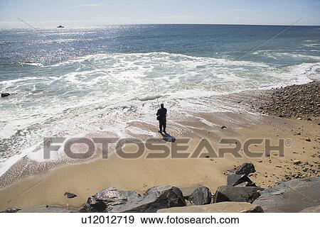 USA, New York, Long Island, Montaurk, Man fishing in sea View Large Photo Image Stock Photo - USA, New York, Long Island, Montaurk, Man fishing in sea. Fotosearch