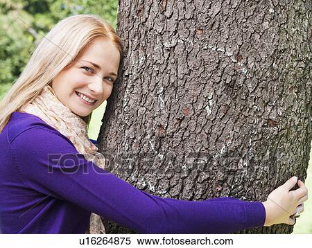 USA, New York, New York City, Manhattan, Central Park, Young woman embracing tree View Large Photo Image Stock Photography - USA, New York, New York City, Manhattan, Central Park, Young woman embracing tree. Fotosearch