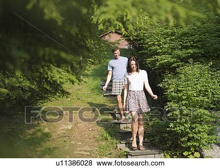 USA, New York, Putnam Valley, Roaring Brook Lake, Couple walking down steps among trees View Large Photo Image Stock Photo - USA, New York, Putnam Valley, Roaring Brook Lake, Couple walking down steps among trees. Fotosearch