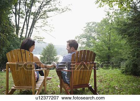 USA, New York, Putnam Valley, Roaring Brook Lake, Couple relaxing by lake View Large Photo Image Stock Photo - USA, New York, Putnam Valley, Roaring Brook Lake, Couple relaxing by lake. Fotosearch