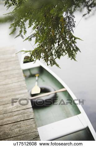 Stock Photo - USA, New York, Putnam Valley, Roaring Brook Lake, Boat moored at pier. Fotosearch