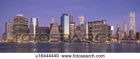 Stock Image - USA, New York State, New York City, City skyline at dusk. Fotosearch